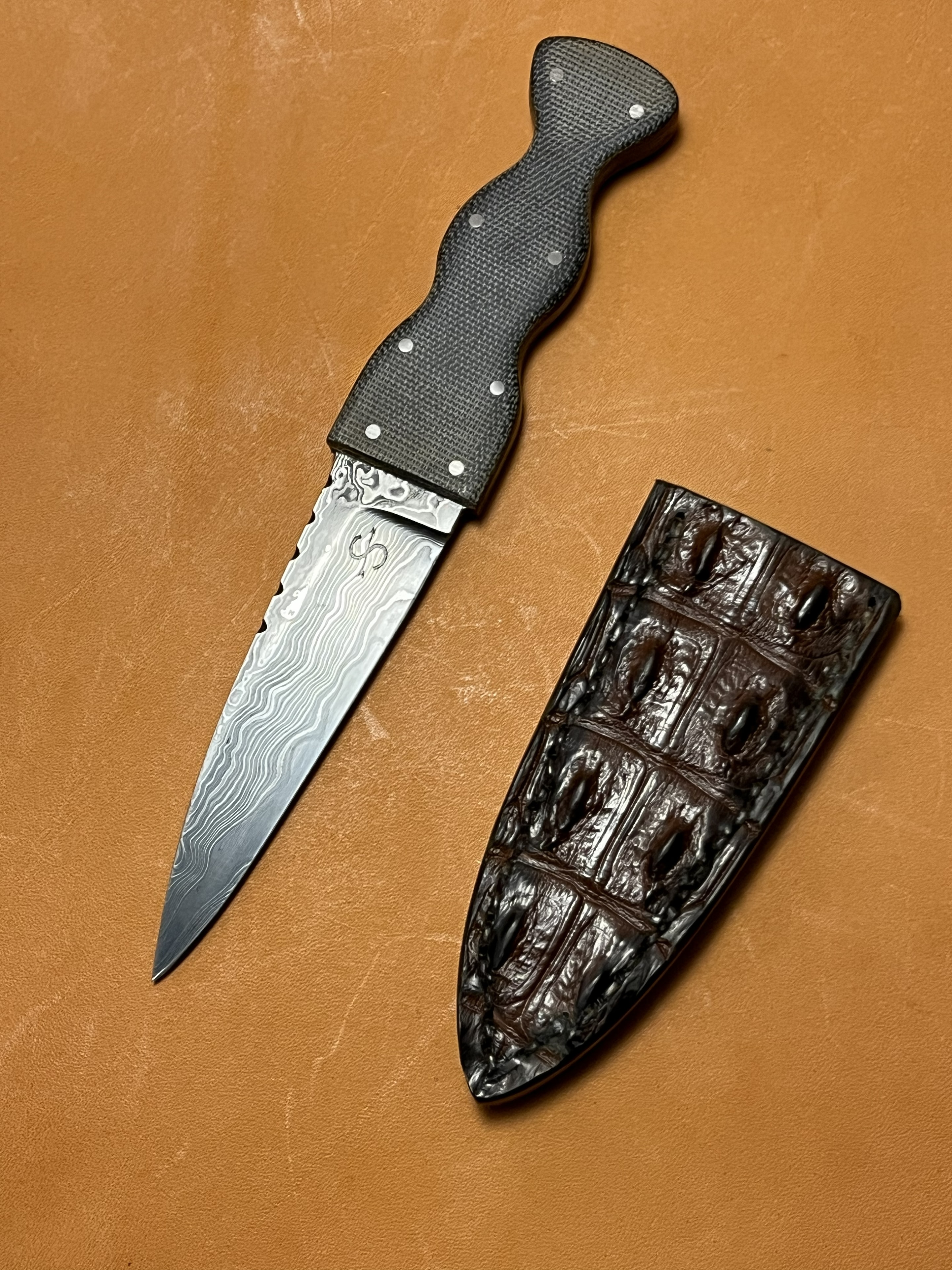 Damascus dagger with micarta handle and crocodile sheath