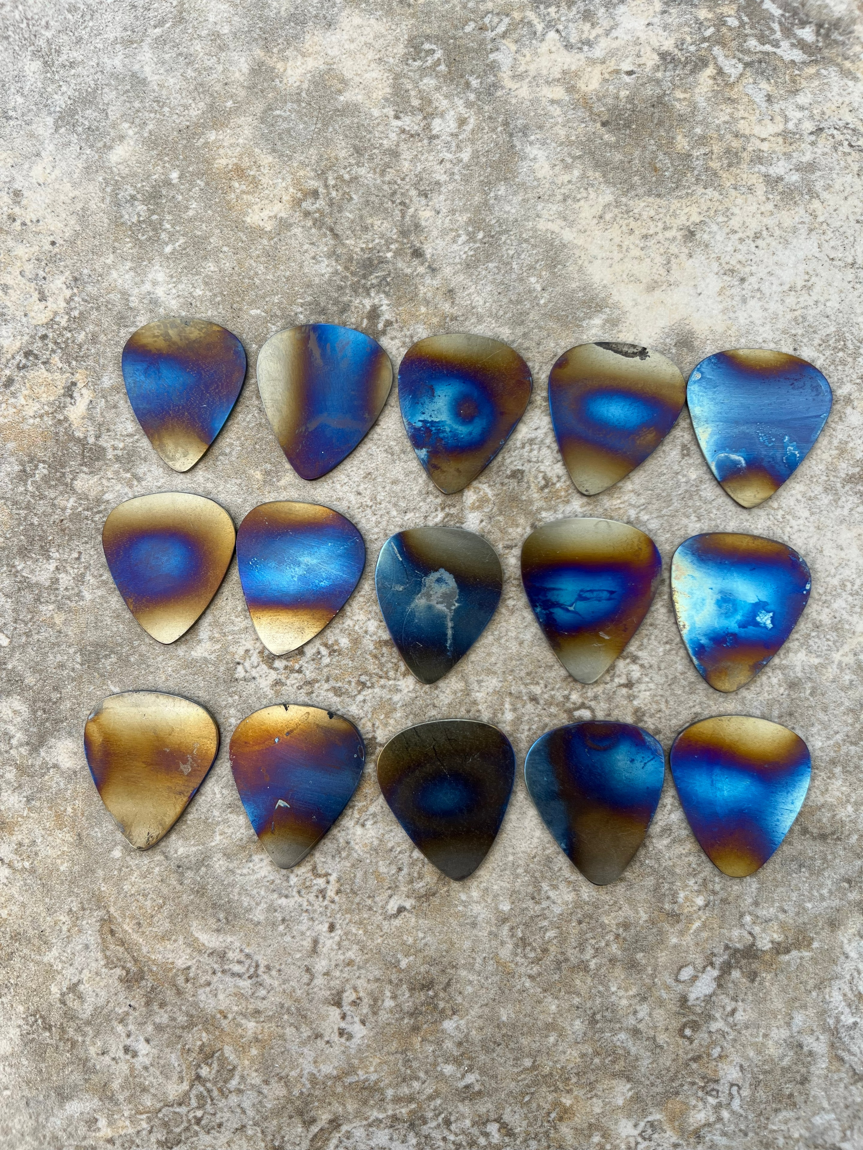 Guitar picks — heat-treated steel with blue and gold finish